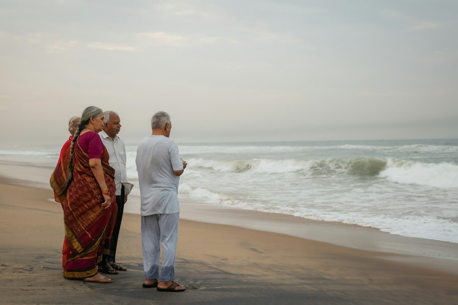 An elderly couple standing together by the sea