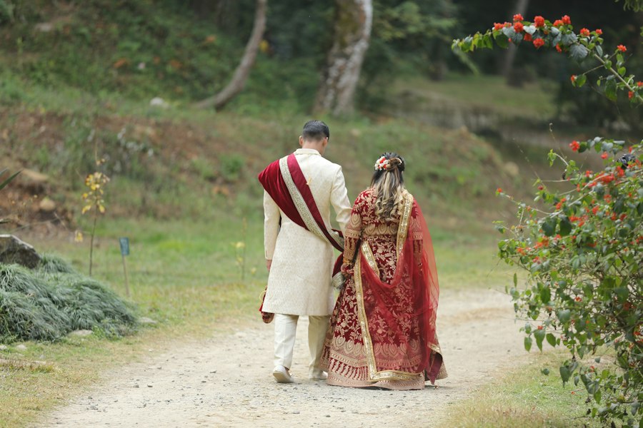 A couple in wedding dress walking together outdoors