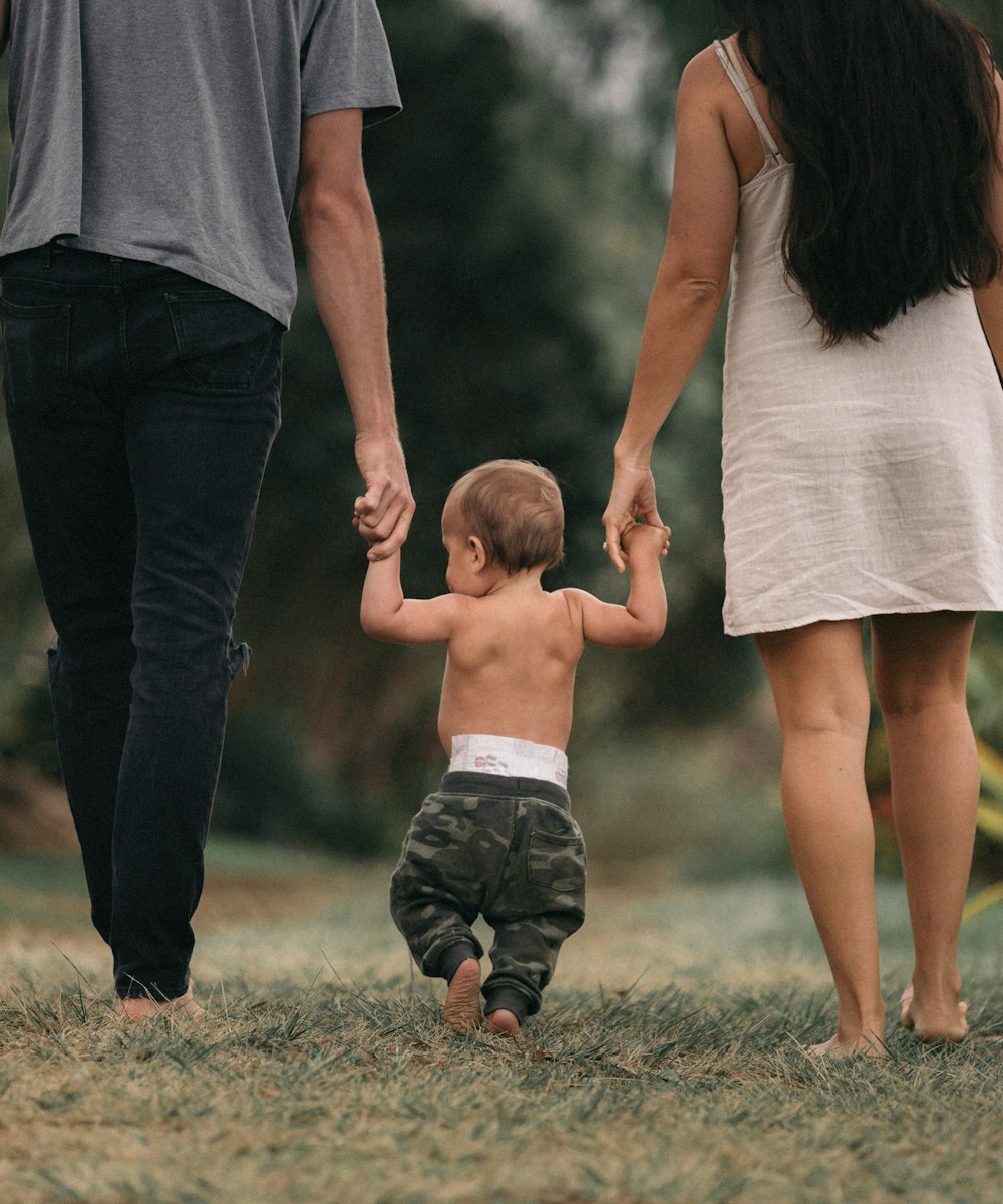 Parents walking with their child between them