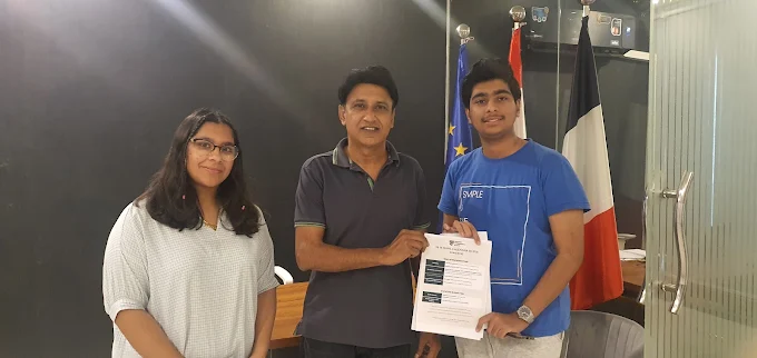 Two students receiving their admission letter at the Westside office