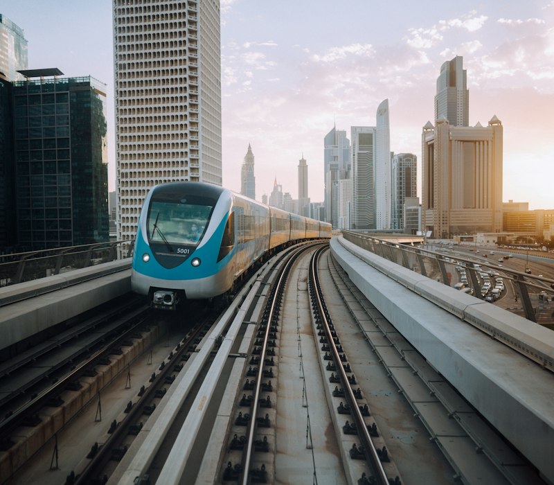 The Dubai Metro gliding past towers