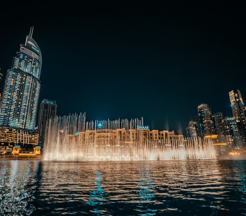 The Dubai Fountain dancing below Burj Khalifa at night
