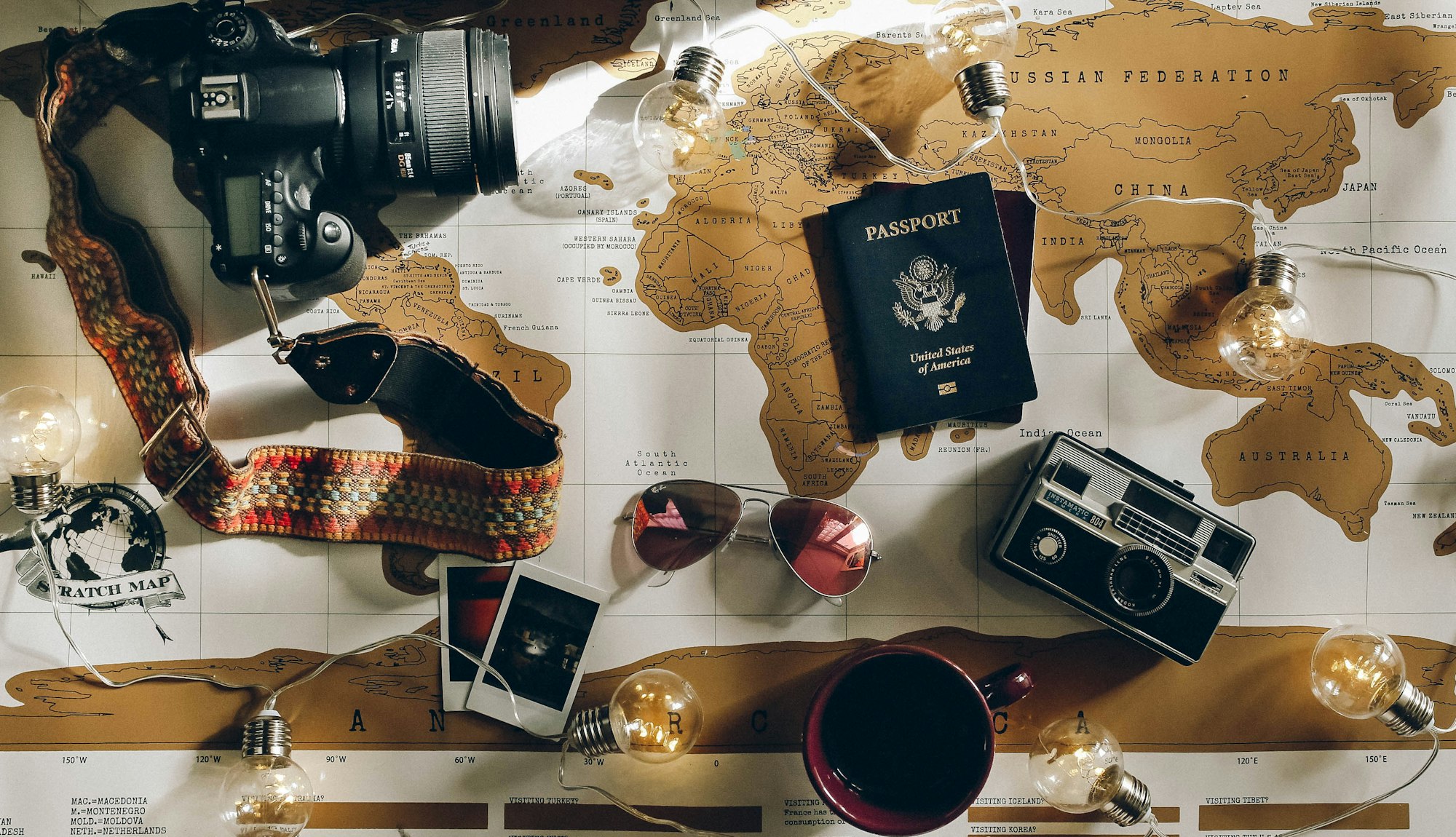 Passports, a map and a camera laid out for planning a trip abroad