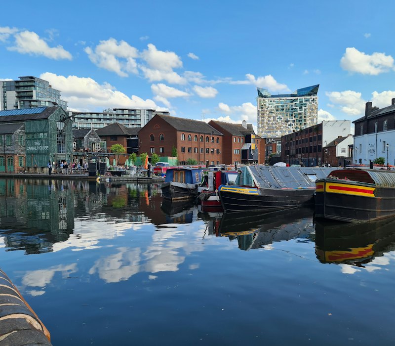 Colourful canal boats reflected in Birmingham's canals