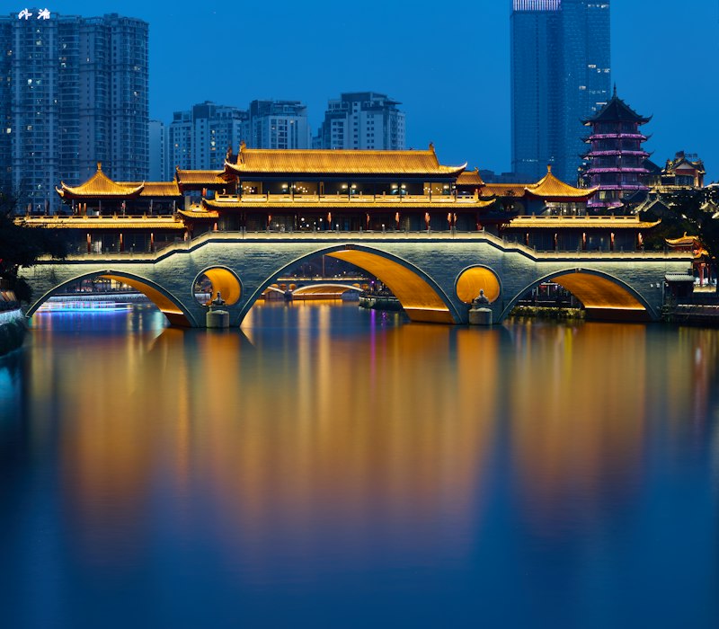 The lit Anshun Bridge over the river in Chengdu at night
