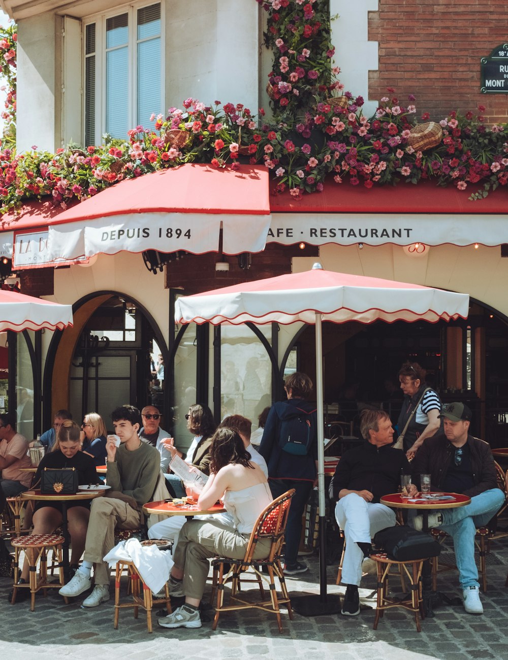 A busy Paris café terrace full of people