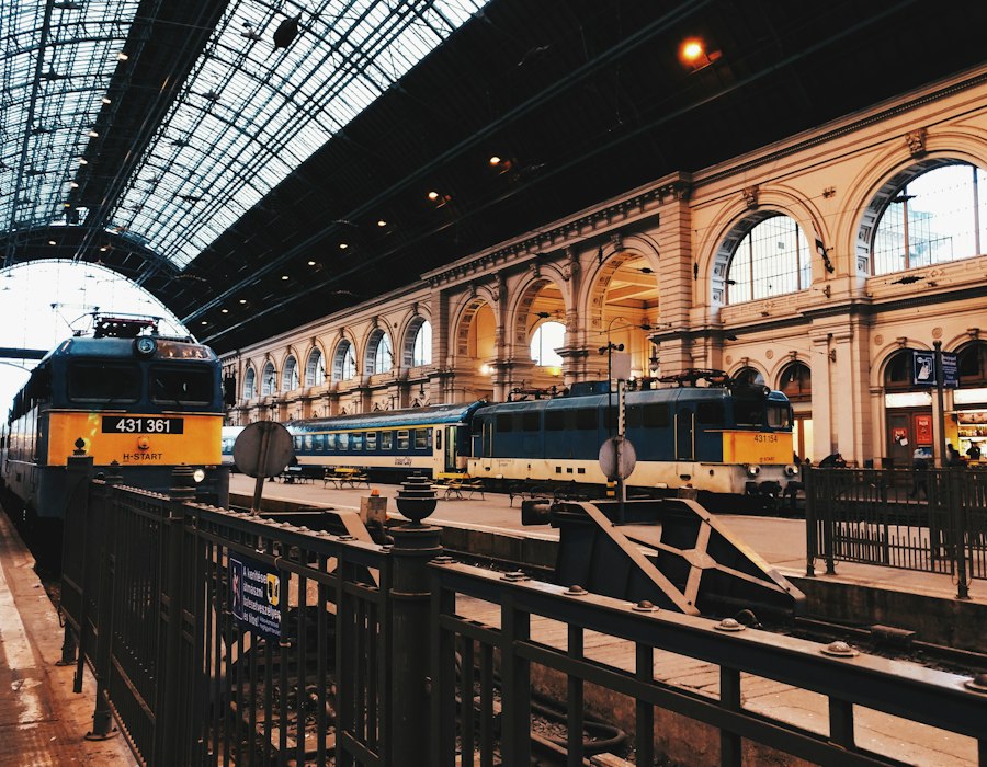 A colourful train at a grand European railway station