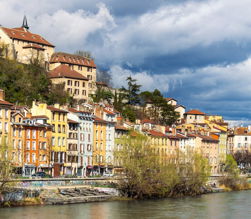 Colourful houses below the mountains in Grenoble