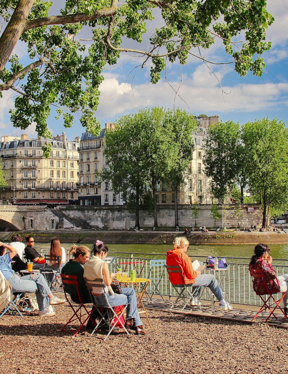 Friends relaxing on the banks of the Seine in Paris