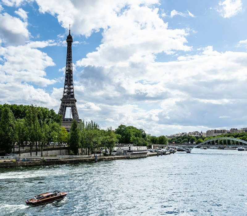 The Eiffel Tower above the Seine on a summer day