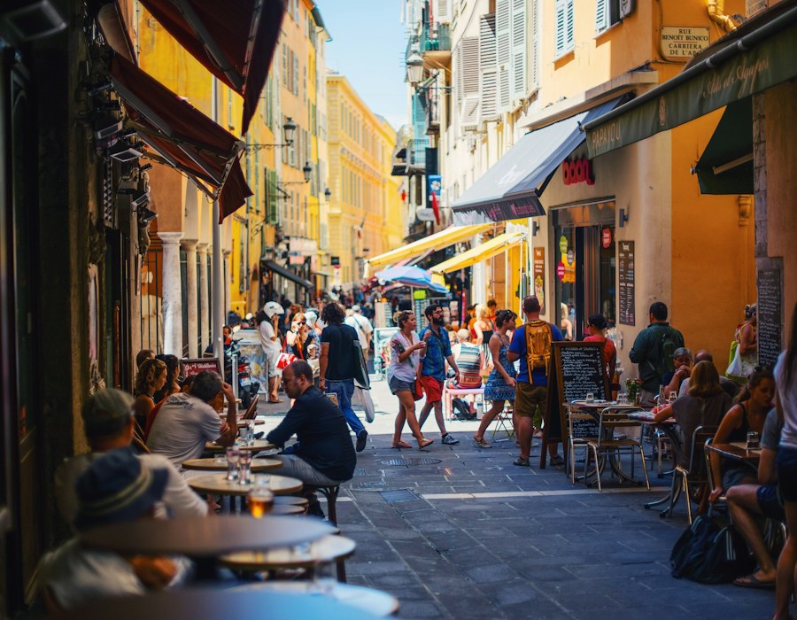 A lively old town street full of cafés in Nice