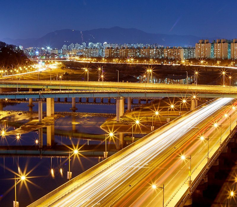 A lit bridge over the river in Daejeon at night