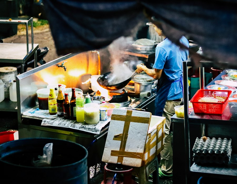A cook at a Malaysian street food stall