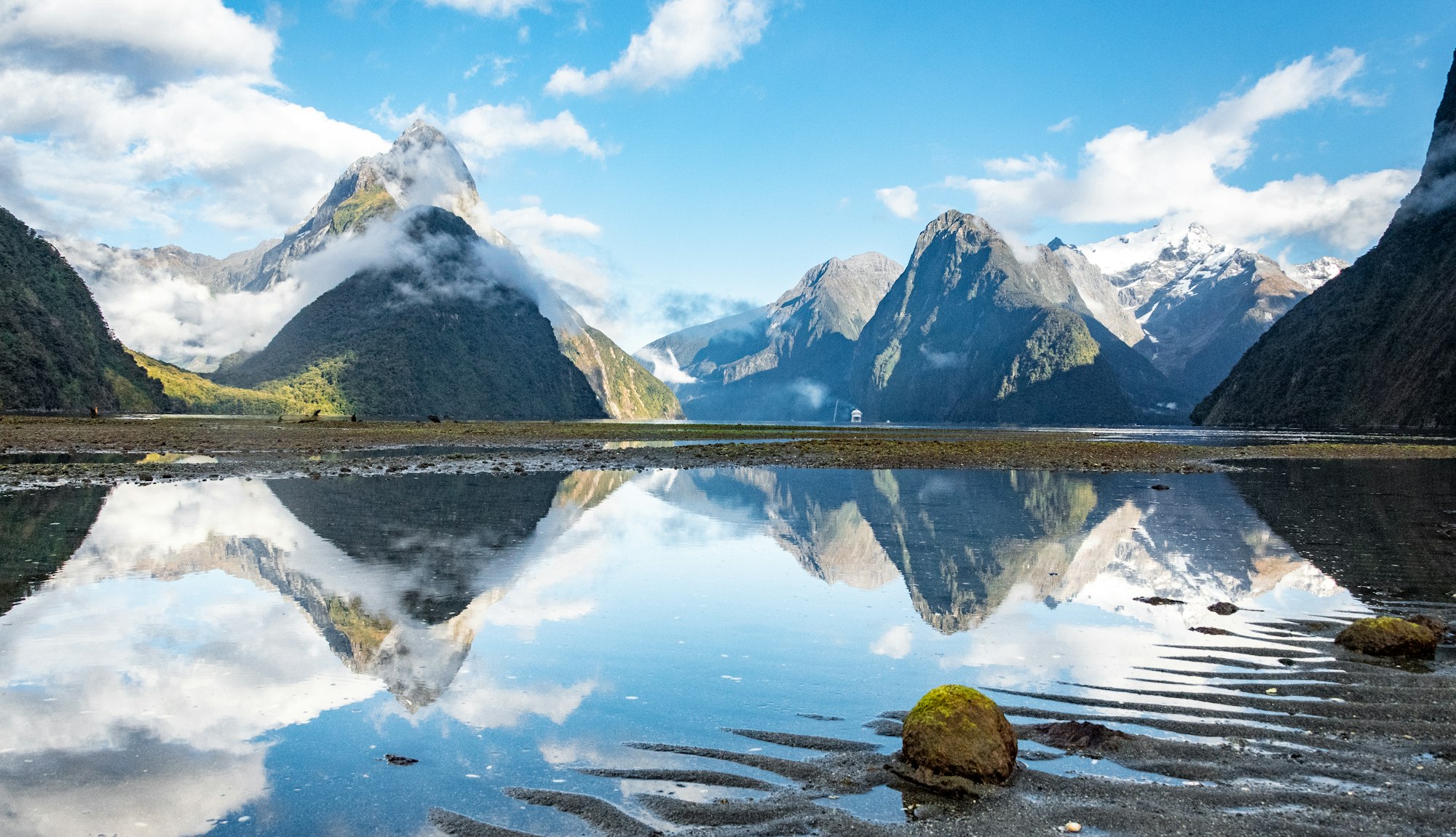 Mountains mirrored in the still water of Milford Sound