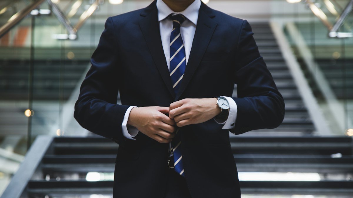 A man in a suit getting ready