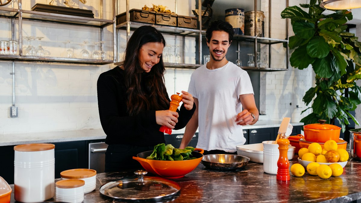 A couple cooking together at home
