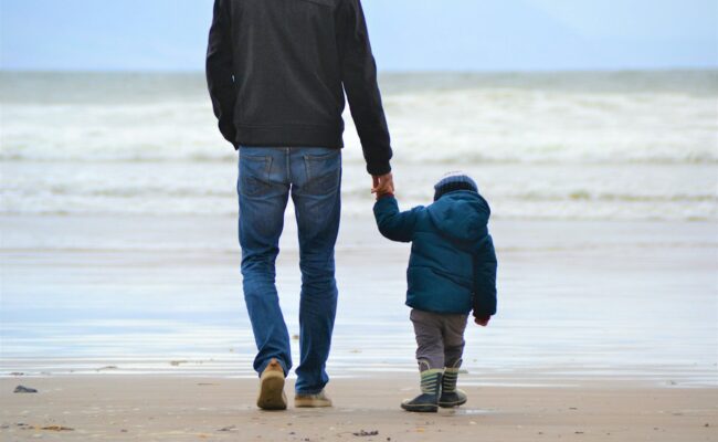 A parent and child walking together