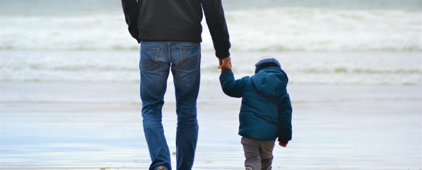 A parent and child walking together