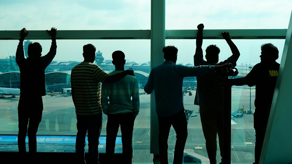 Young adults standing together at sunset