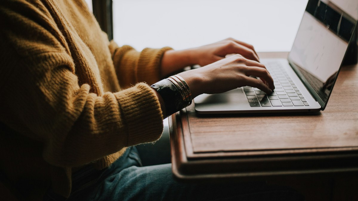 A student researching universities on a laptop