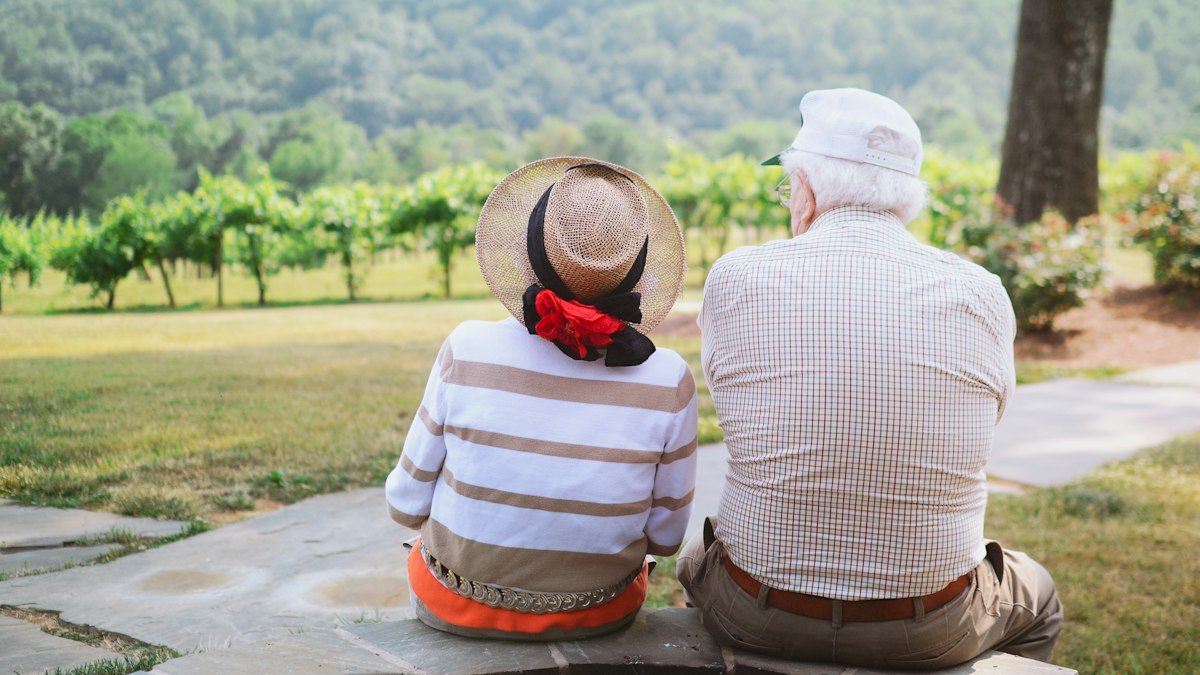 An older couple sitting in a park