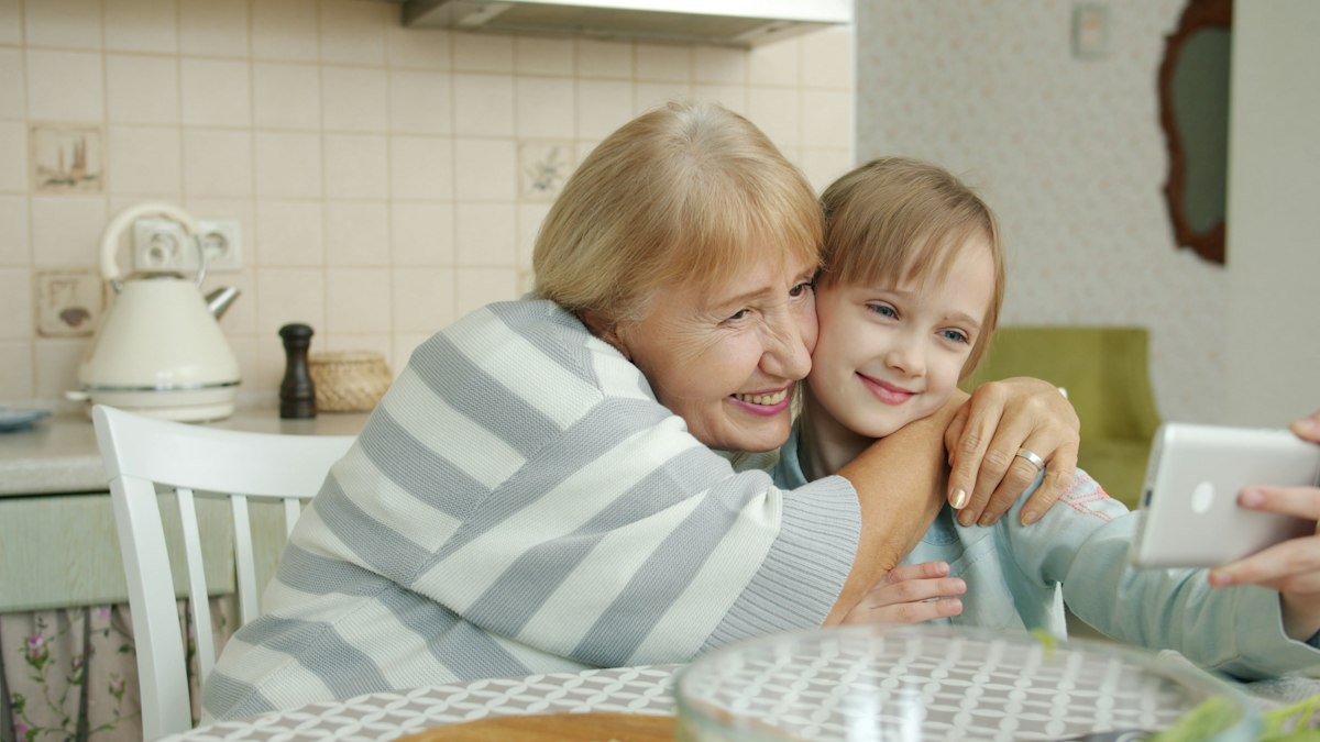 A grandmother and granddaughter smiling together