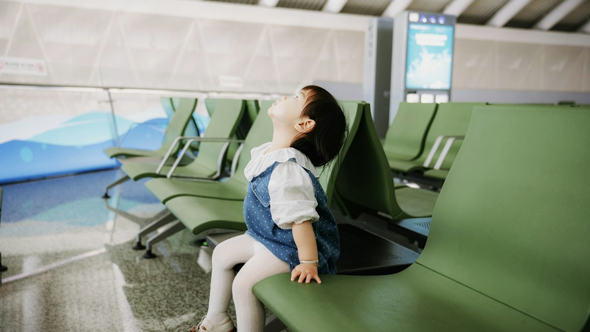 A child watching planes at an airport
