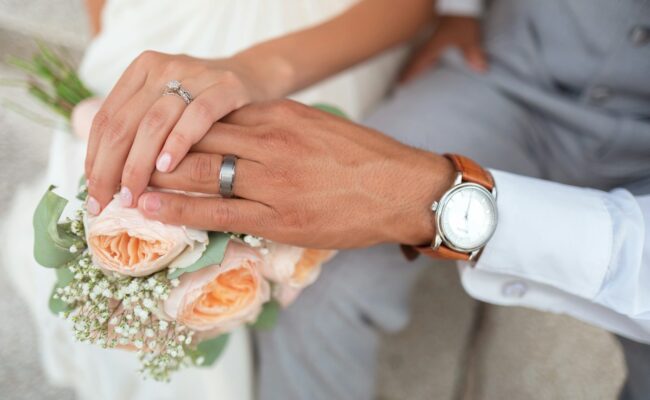 A couple's hands with wedding rings