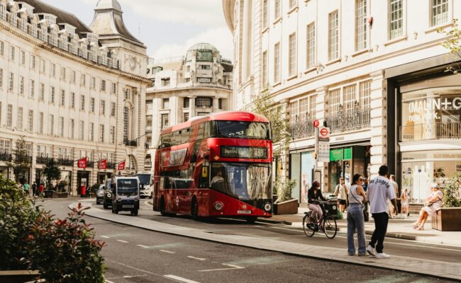 A red London bus on a busy street