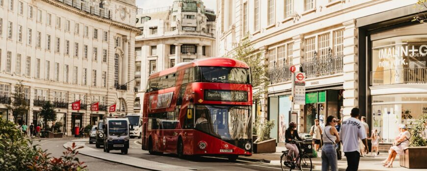 A red London bus on a busy street