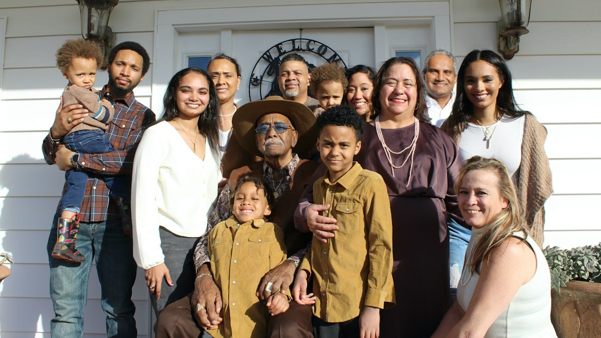 A large family group smiling together