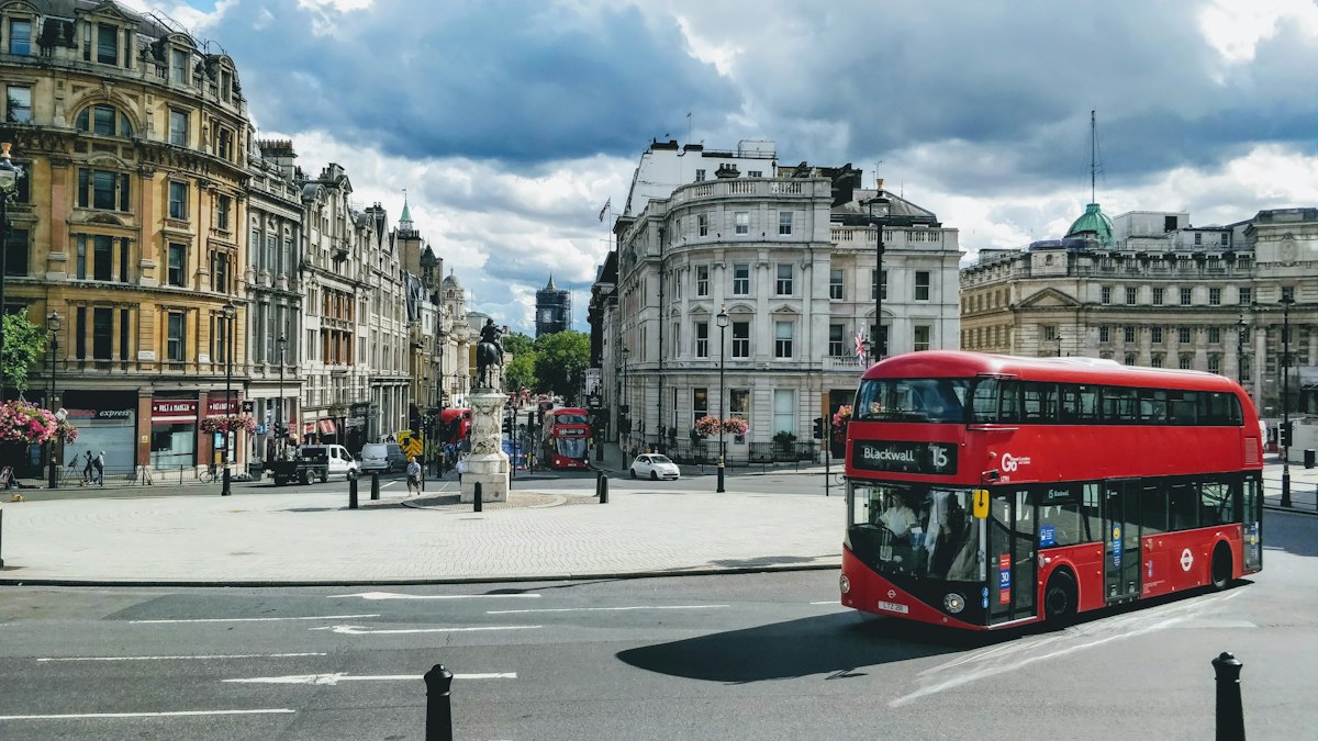 A red London bus on a city street