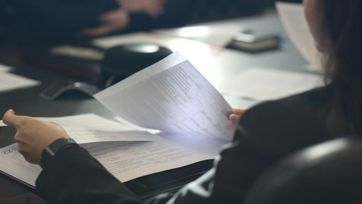 A person reading an official letter