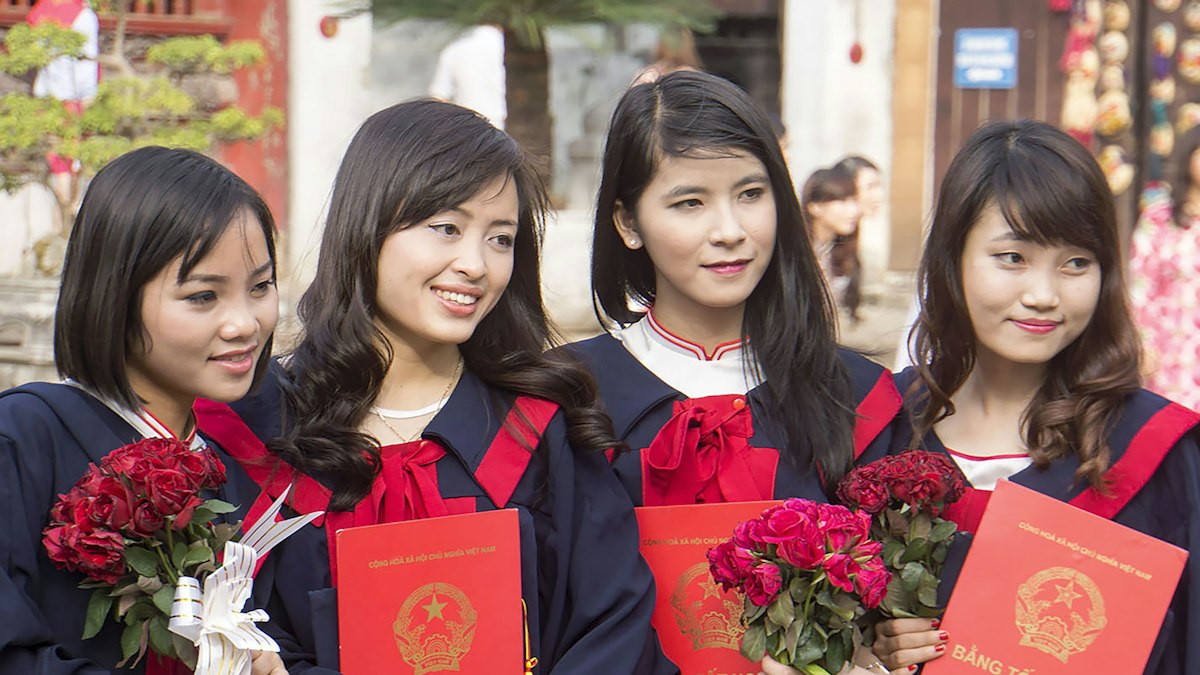 Graduates holding certificates at a ceremony