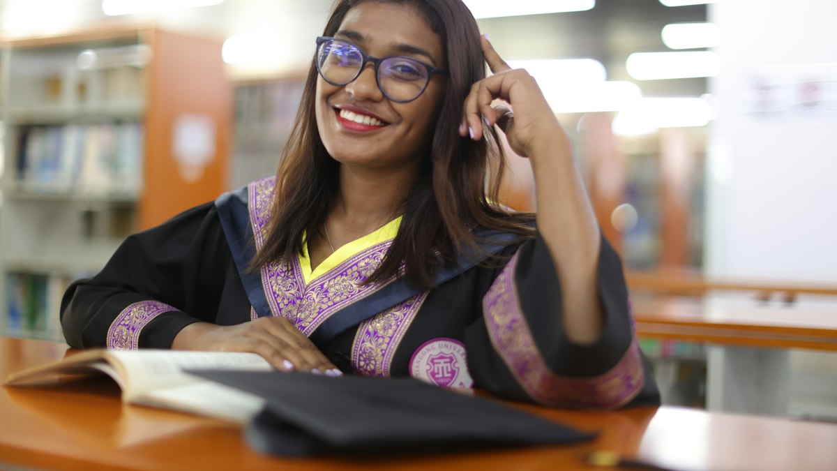 A smiling student in a library