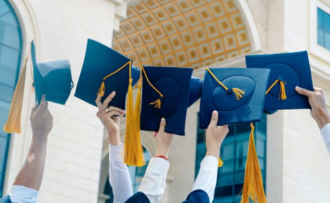Graduation caps thrown in the air