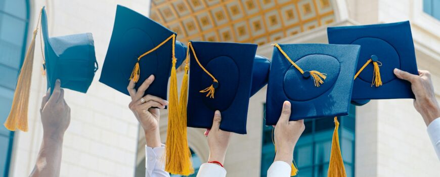 Graduation caps thrown in the air