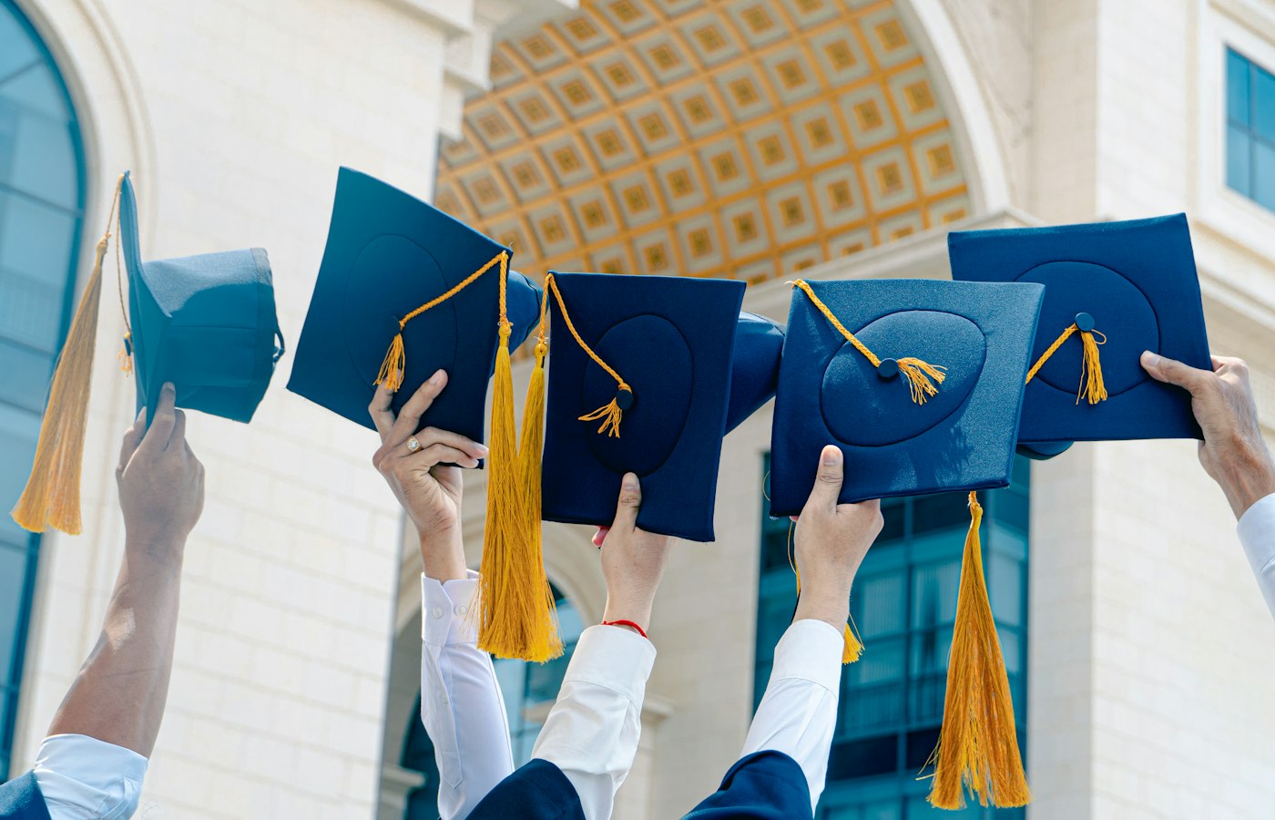 Graduation caps thrown in the air