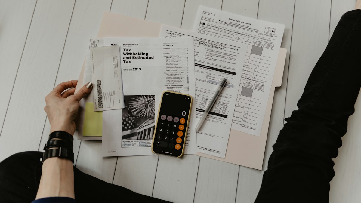 Financial documents and a calculator on a desk