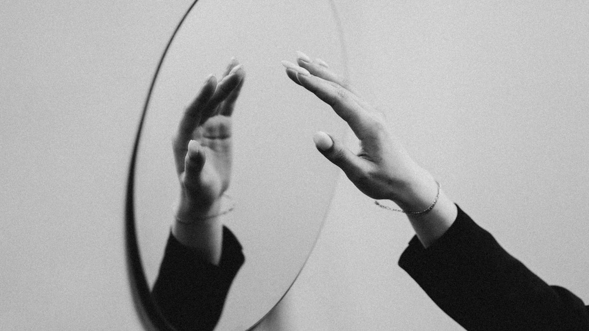 Hands practising gestures in front of a mirror