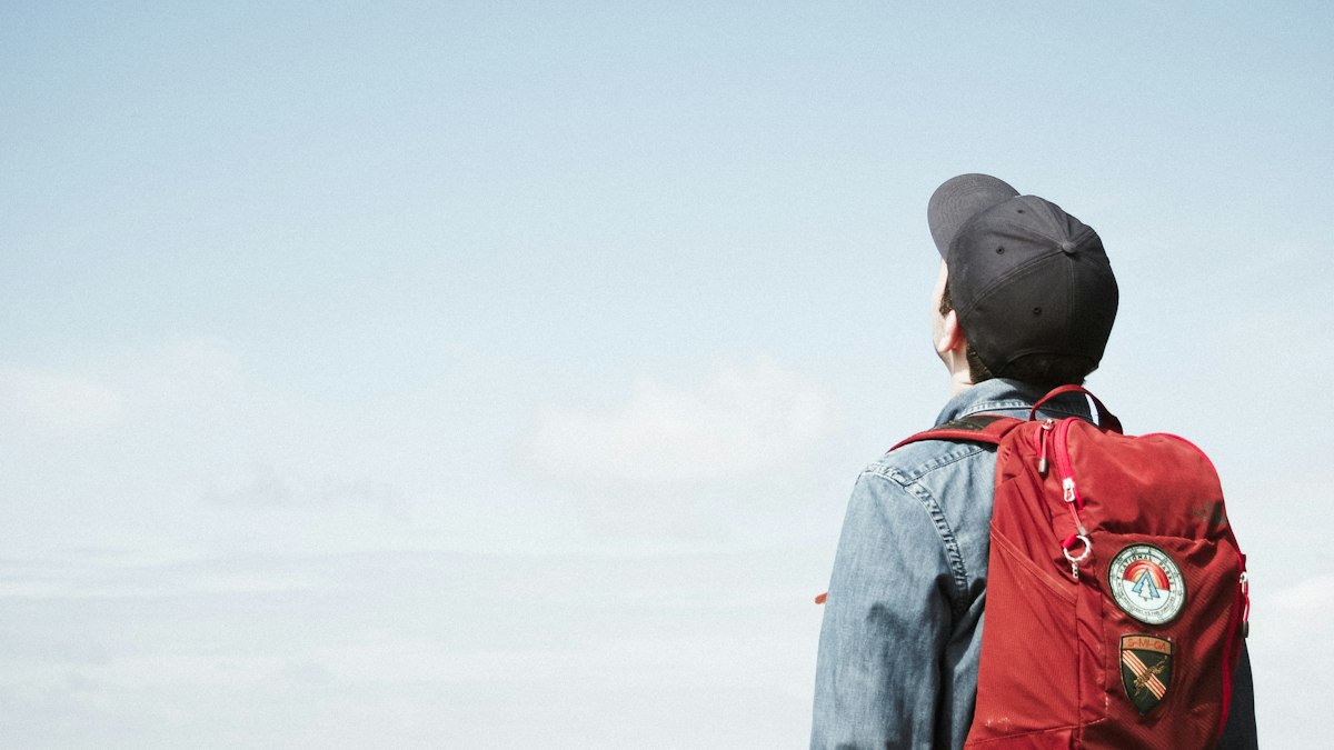 A traveller with a backpack looking ahead