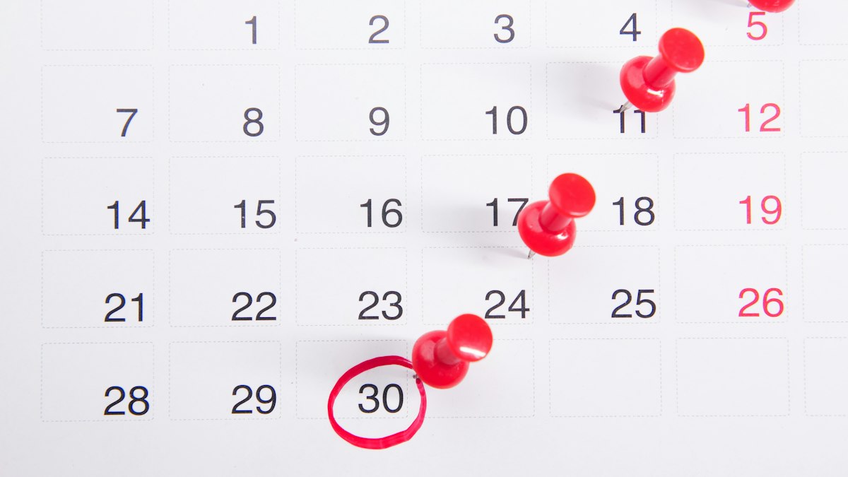 A calendar with deadlines marked by pins