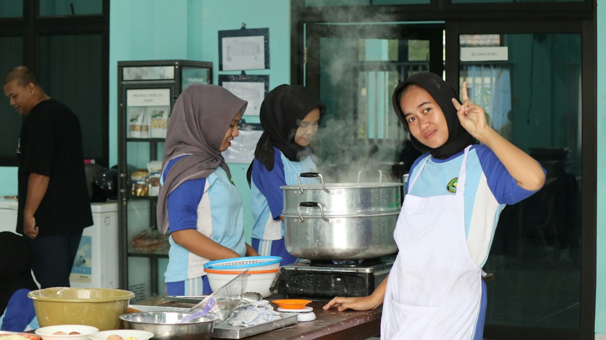 Students cooking together in a shared kitchen