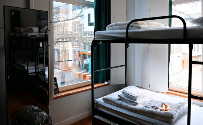 A simple student room with a bed and desk