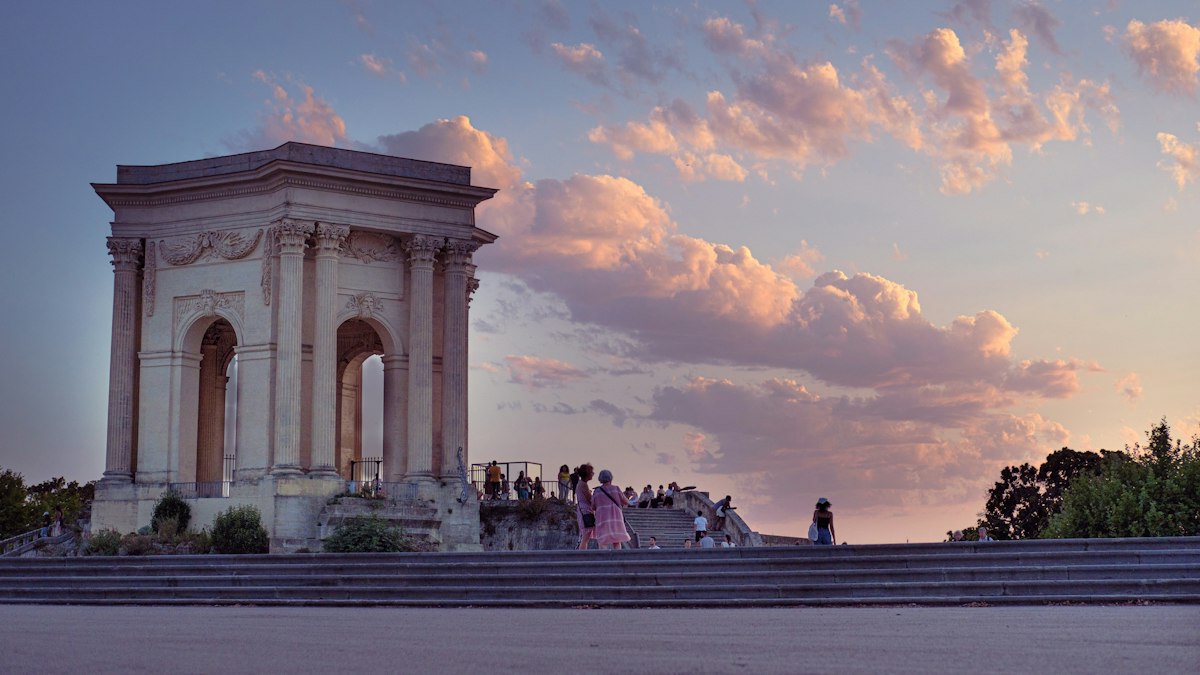 A historic arch in Montpellier at sunset