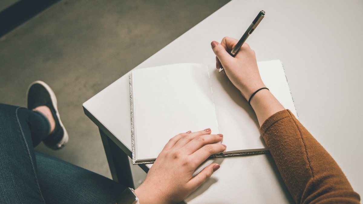 A student writing notes for a thesis