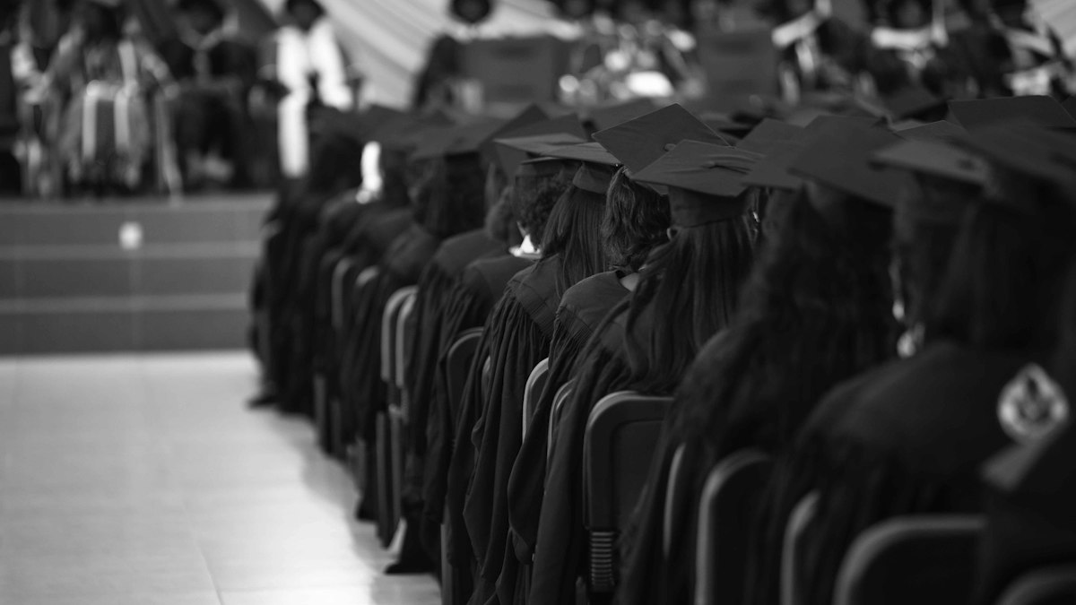 Graduates in gowns at a ceremony