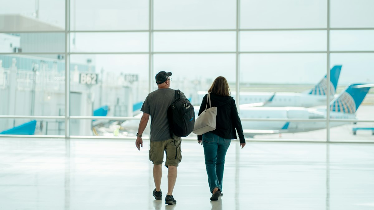 A couple walking through an airport together