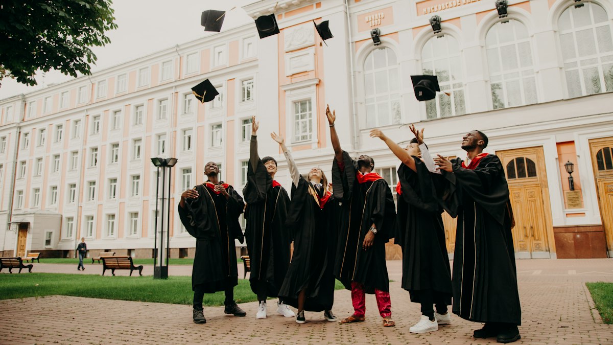 Graduates throwing caps in the air