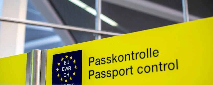 A passport control sign at a European airport